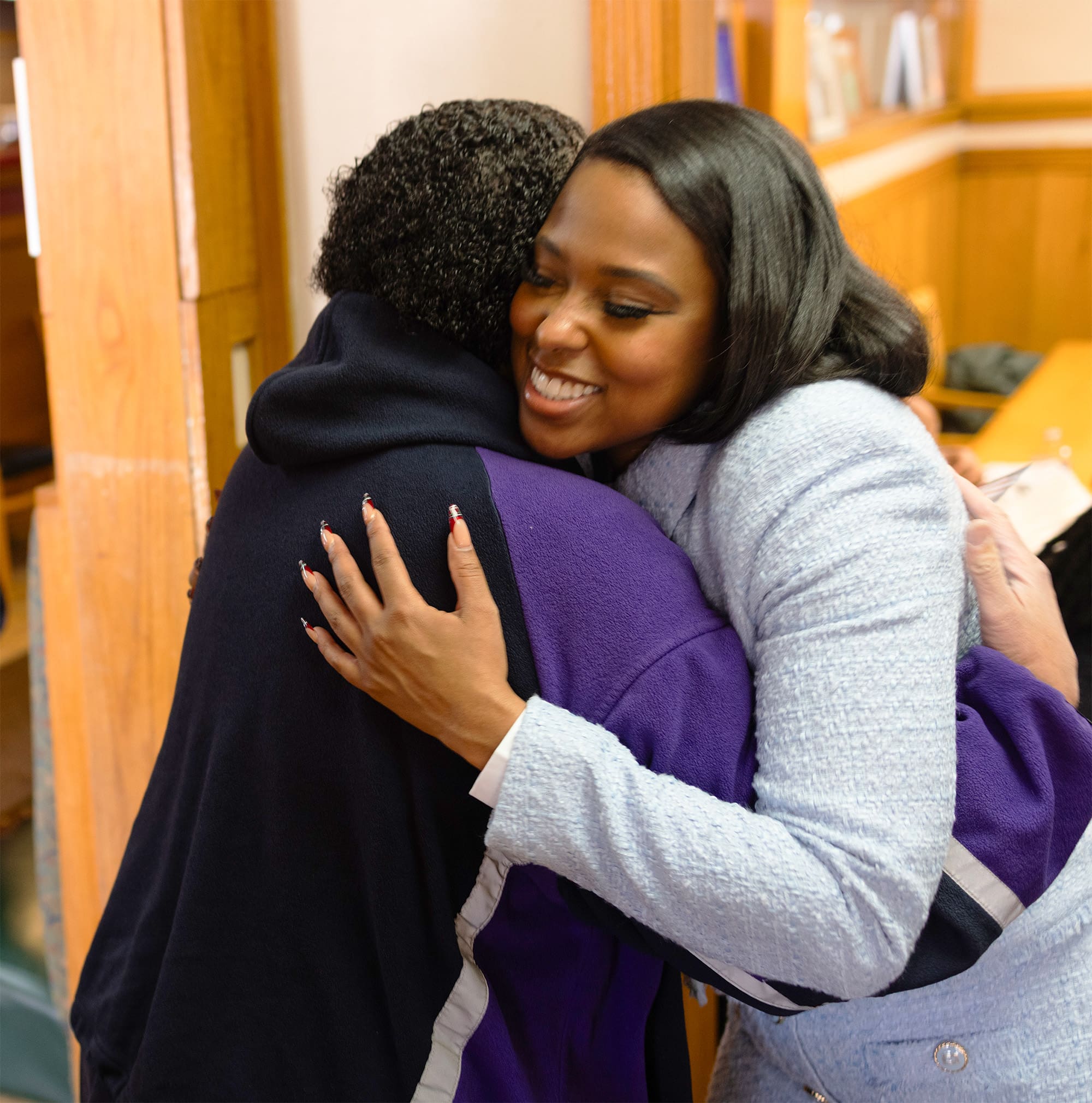 Shantel hugging a black member of the community at an event